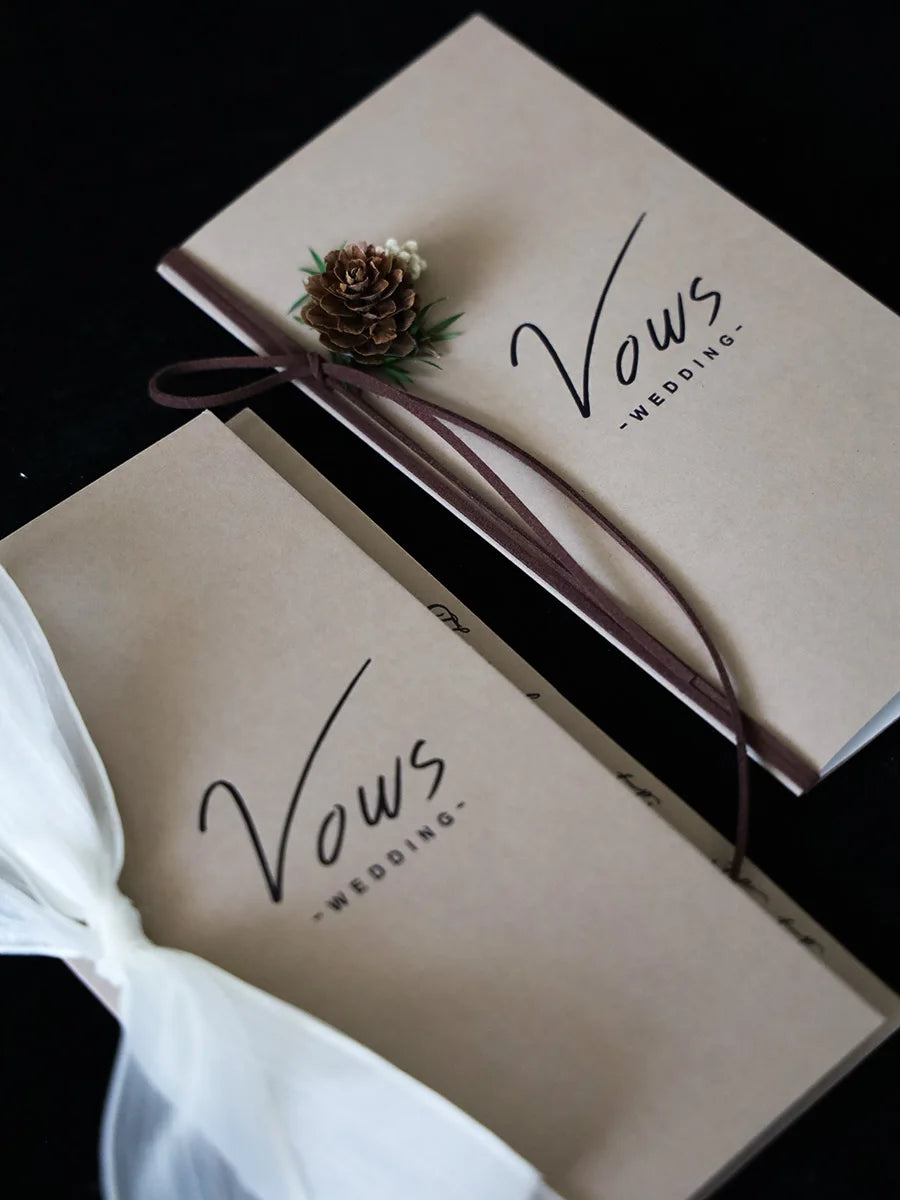 Ivory wedding vow booklet set with gold foil “Vows” and ribbon tie, two booklets shown