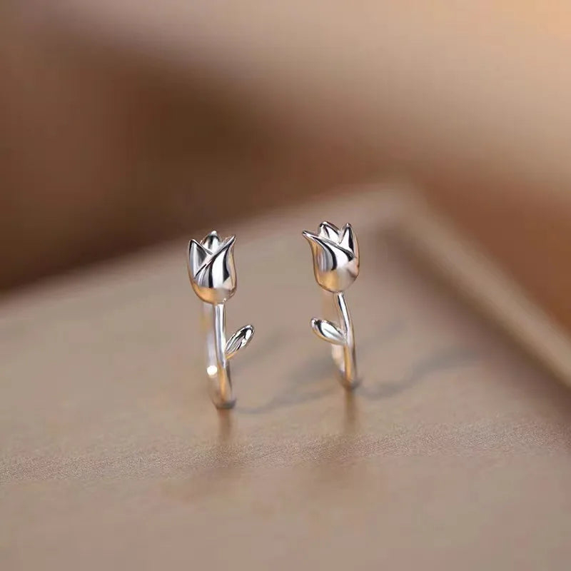 Silver tulip flower stud earrings with upright petal details on thin post backs.