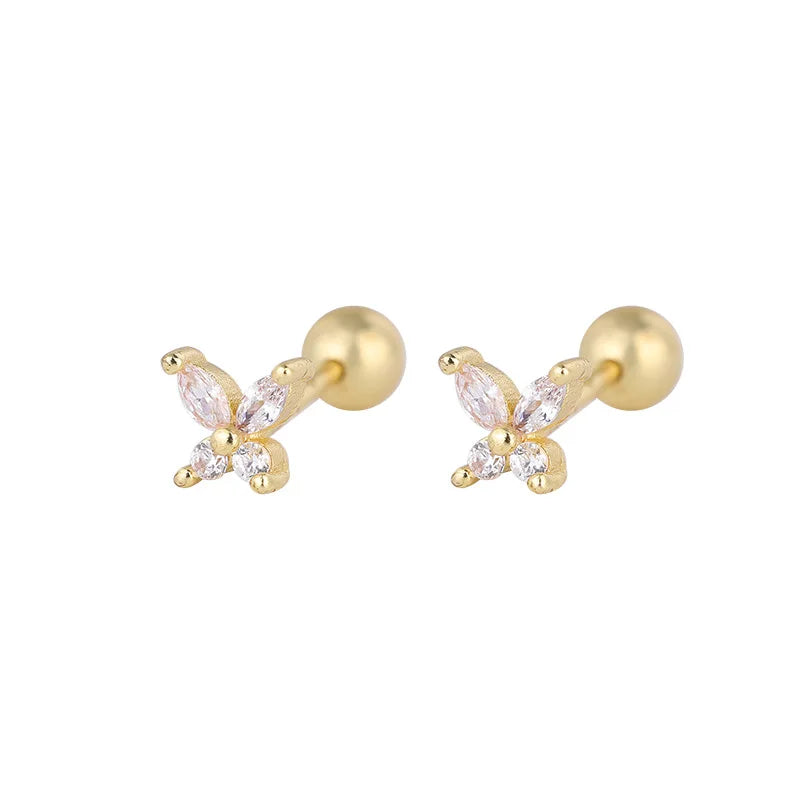 Gold-tone huggie hoop earrings with butterfly-like pink crystal charm