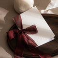 Embossed wedding vow booklet with burgundy organza ribbon bow, 'Our Vows' embossed