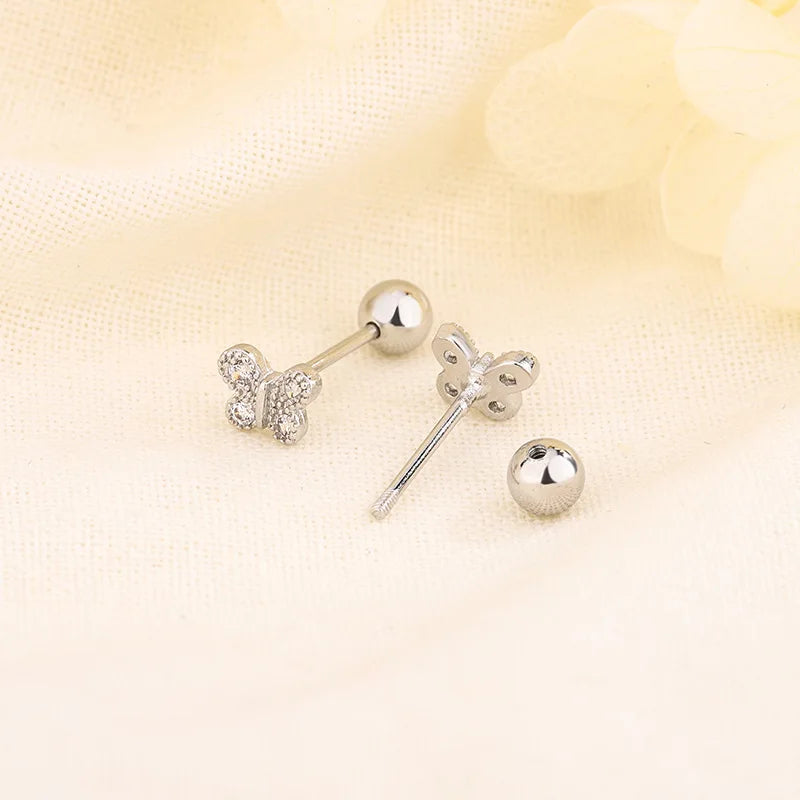 Silver-tone huggie hoop earrings with small crystal flower studs