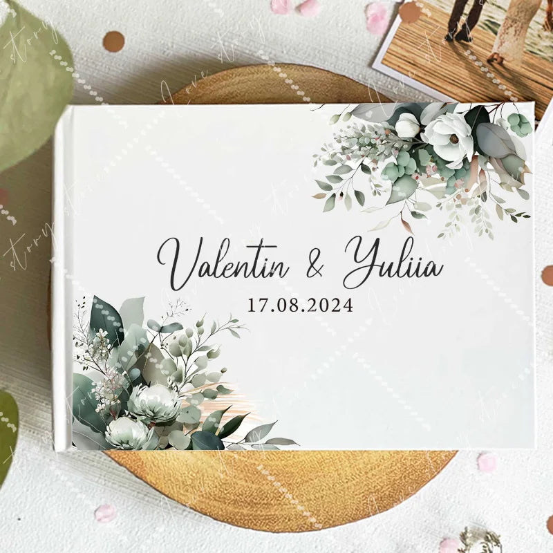Wedding guest book cover with eucalyptus foliage and white flowers; names and date 17.08.2024