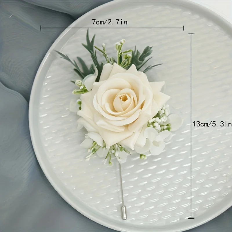 Champagne rose silk boutonniere with white filler, greenery, and pin