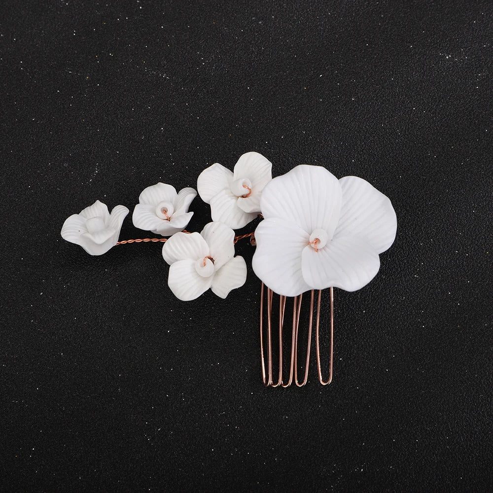 Bridal hair comb with white orchids, small buds, and gold-tone pins