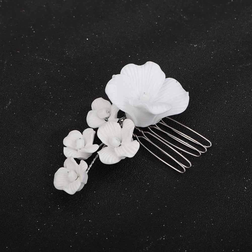 Bridal hair comb with white orchid bloom cluster and gold-tone prongs