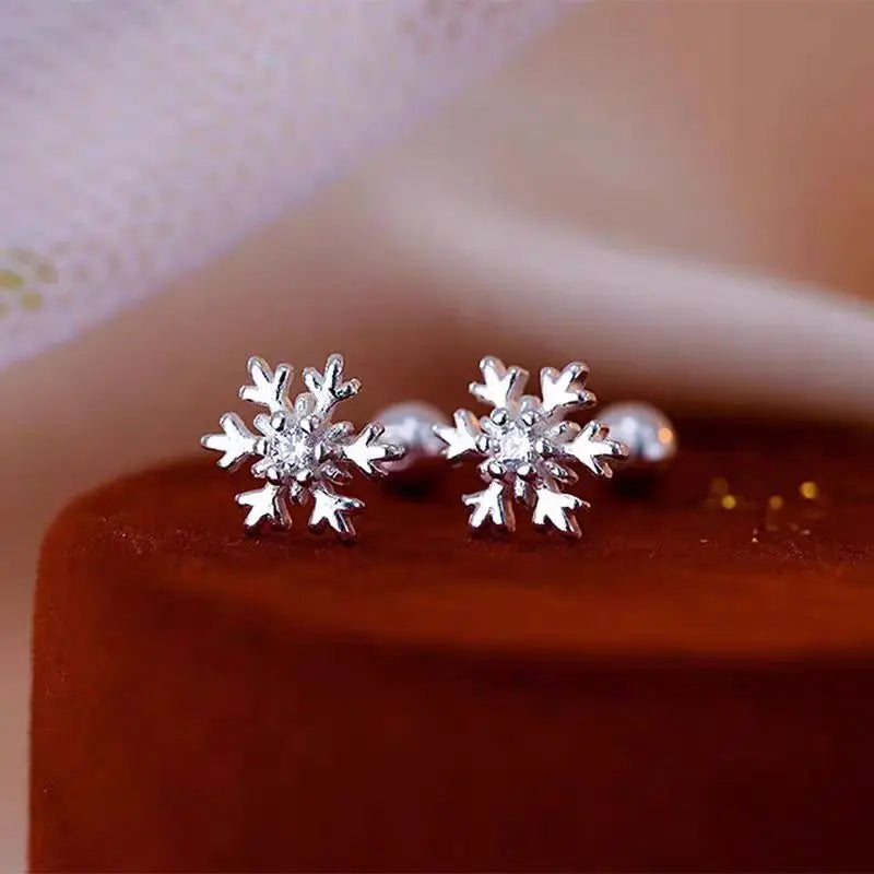Silver-tone stud earrings with snowflake crystal designs