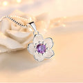 Sterling silver flower crystal pendant necklace with round pink center and purple gem