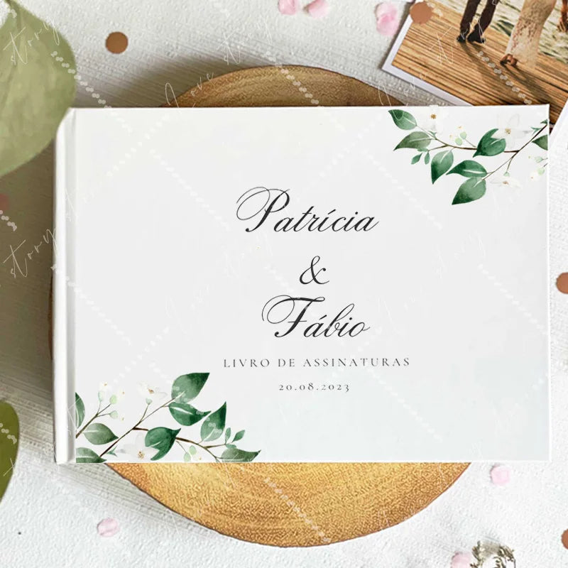 Wedding guest book cover with green leaves framing; centered names and date 20-08-2023