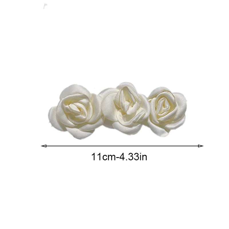 Satin rose clip-on barrette, 11 cm (4.33 in) wide, with three rosettes.