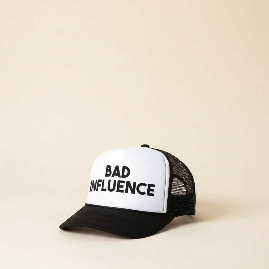 Black trucker cap with white front panel, 'BAD INFLUENCE' text
