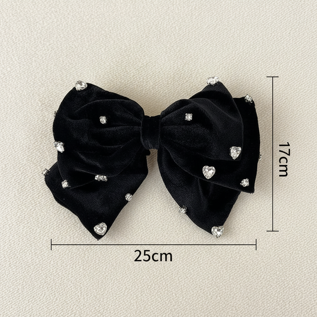 Black fabric bow hair clip with heart-shaped rhinestone accents
