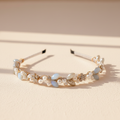 Crystal and pearl headband featuring light blue faceted stones, pearls, and gold-toned details