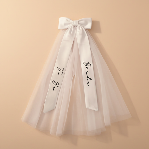 White bridal bow veil with tulle skirt and printed script on ribbon streamers