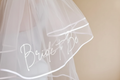 Bride to be veil in white sheer, "Bride to Be" script across front