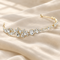 Crystal rhinestone bridal headband with oval and round stones on a light gold-tone band