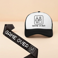 Black and white trucker cap with "Game Over" logo and matching black sash