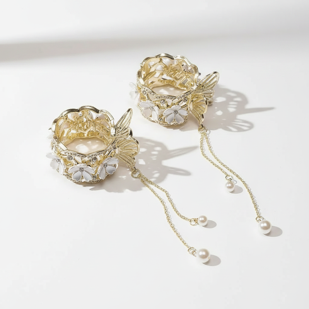 Gold floral hair clip with rhinestone petals and dangling pearl chain drops