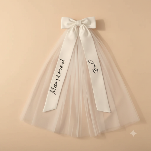 White bridal bow veil with layered tulle and printed script lettering on ribbon streamers