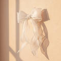 White satin bow hair clip with pearl beading and dangling strings