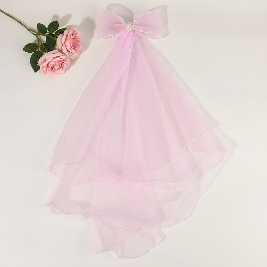 Pink tulle bow hair clip with long sheer veil layers and ribbon bow
