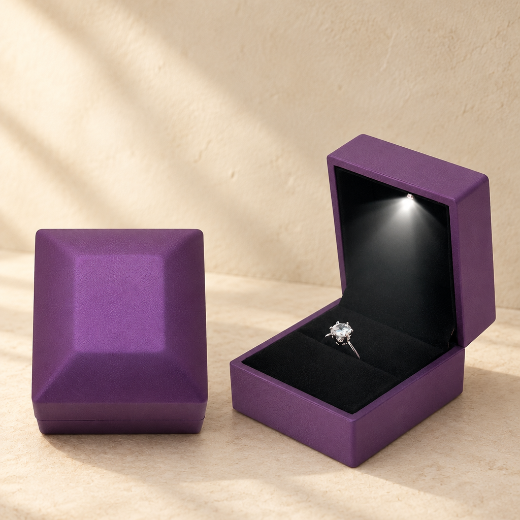 Purple LED proposal ring box with open lid and ring on black velvet insert.