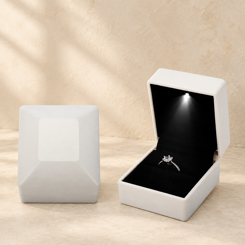 White LED proposal ring box with open lid and ring on black velvet insert.