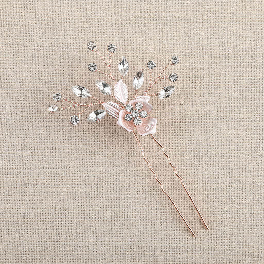 Bridal hair comb center detail with blush petals, crystal leaves, and two pins