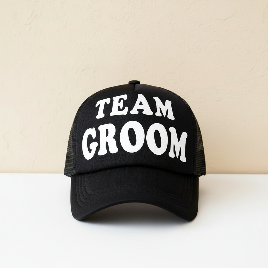 Black trucker cap with white “TEAM GROOM” stacked lettering on the front